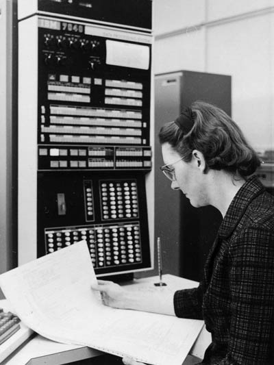 Kathleen Booth examines a computer printout at USask in 1966. (Photography: Gibson Photo, University of Saskatchewan, University Archives and Special Collections, A-8504)