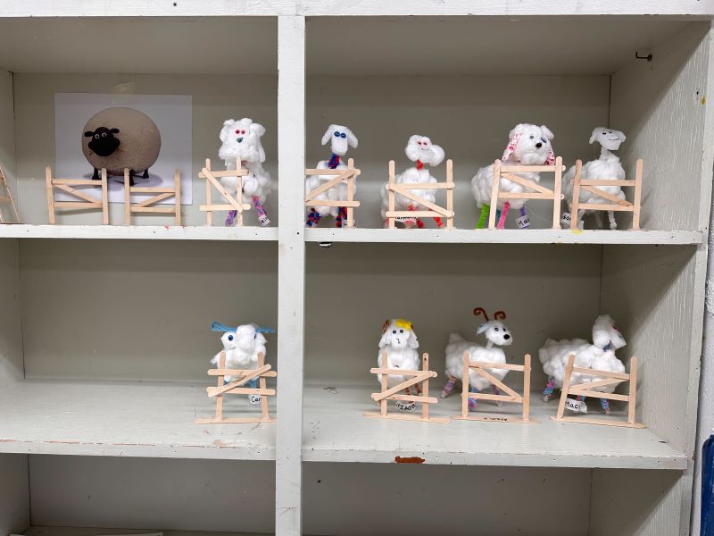 shelf of small sheep sculptures