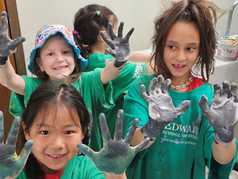 kids with painted hands smiling