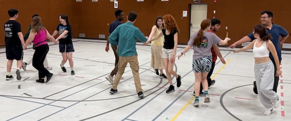 People in a gymnasium folk dancing