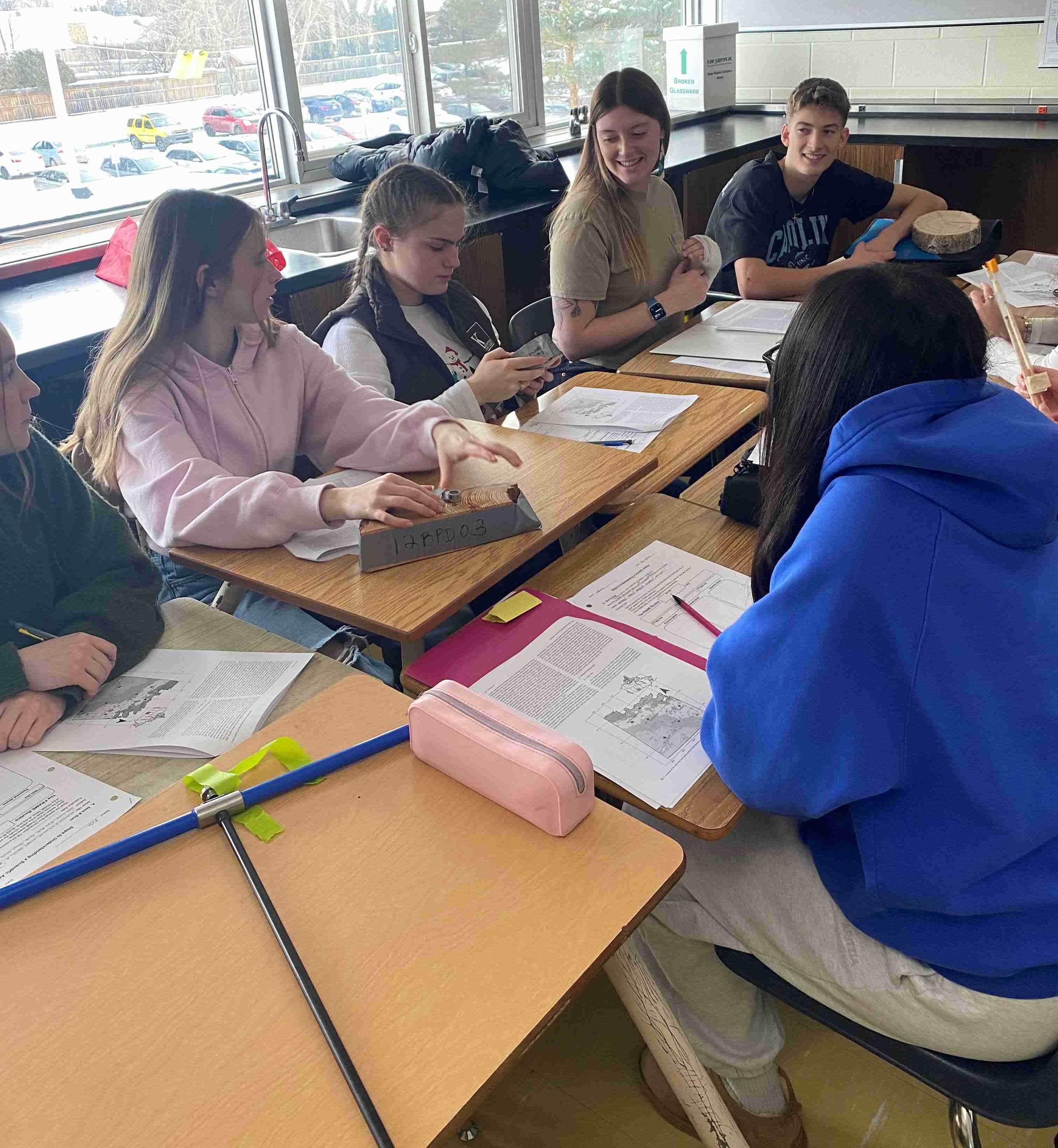 Group of high school students learning about tree ring science